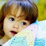 Little girl with crocheted blankie.
